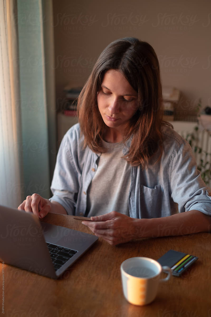 Woman working on laptop from home online payment