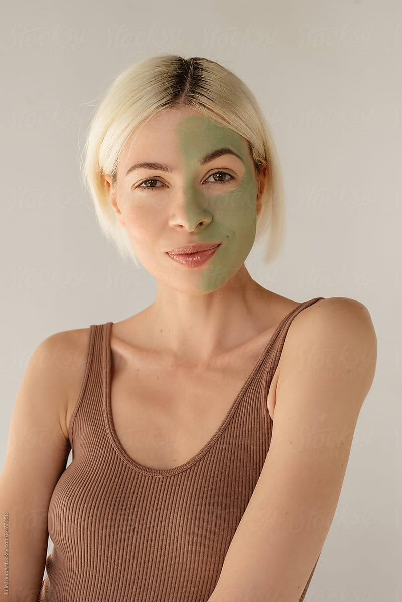A blond girl with half of face cover with mask