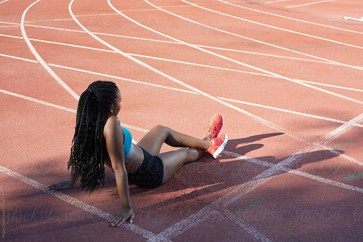 Black athlete relaxing on track and field