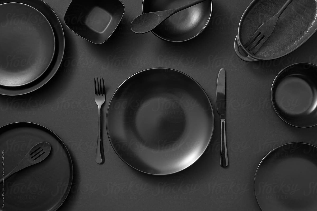 Served kitchen table with black cookware.