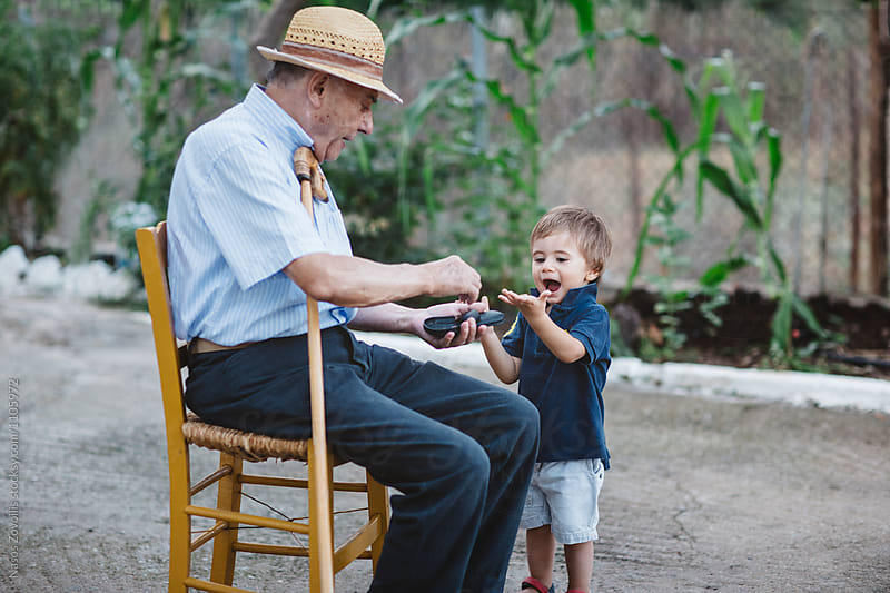 Grandfather giving money to his grandchild