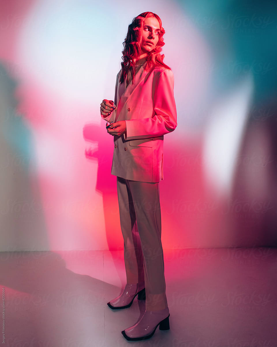 Transgender portrait full body in pink suit