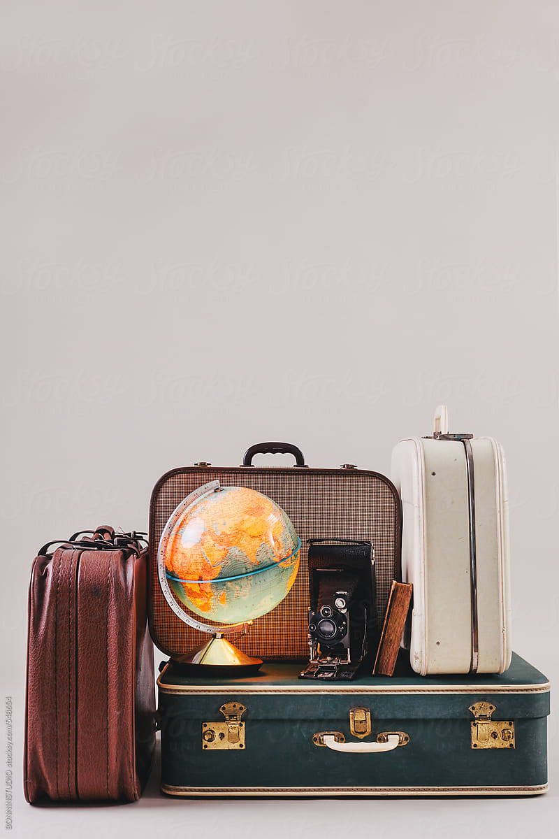 Vintage Suitcases With A Globe, Old Camera And Antique Book. | Stocksy ...