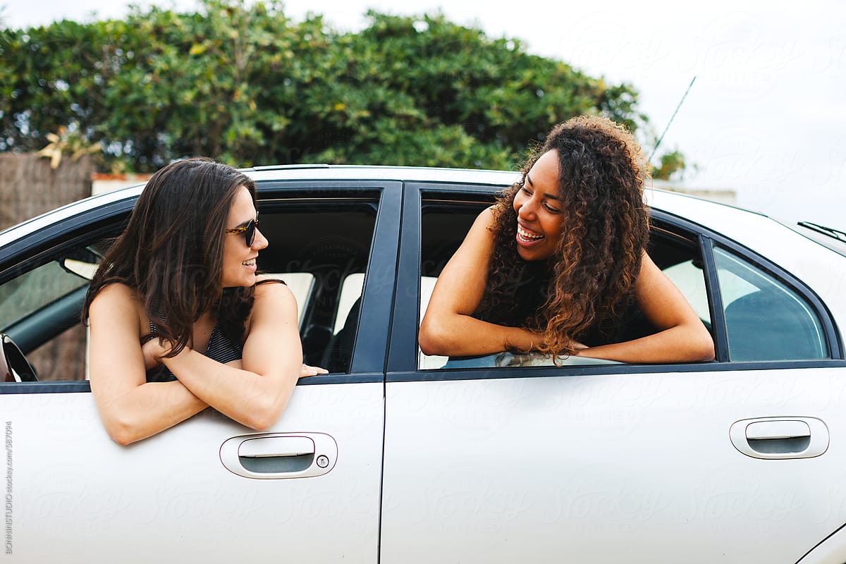 Portrait Of Two Young Woman Inside A Car On A Summer Road Trip By Stocksy Contributor