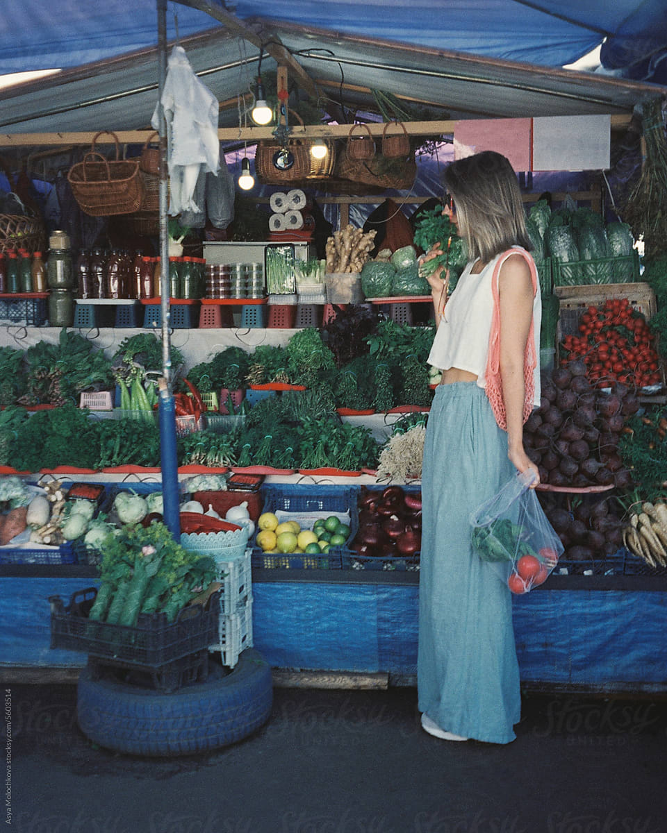 Buying fresh vegetables  at the market outdoors