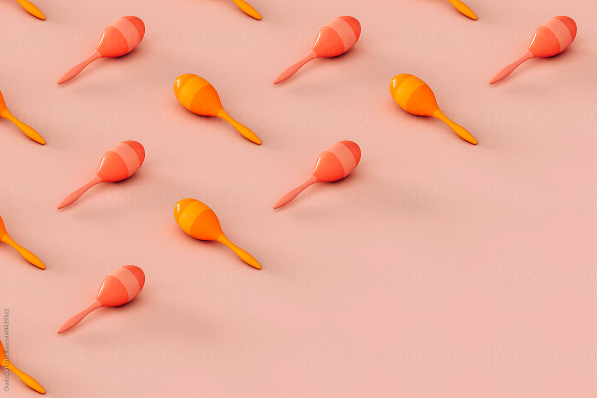 collection of colorful maracas on a pink background