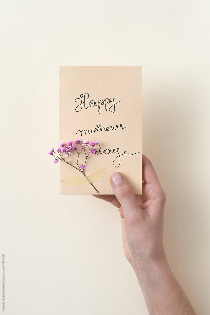 Female hand holding paper greeting card