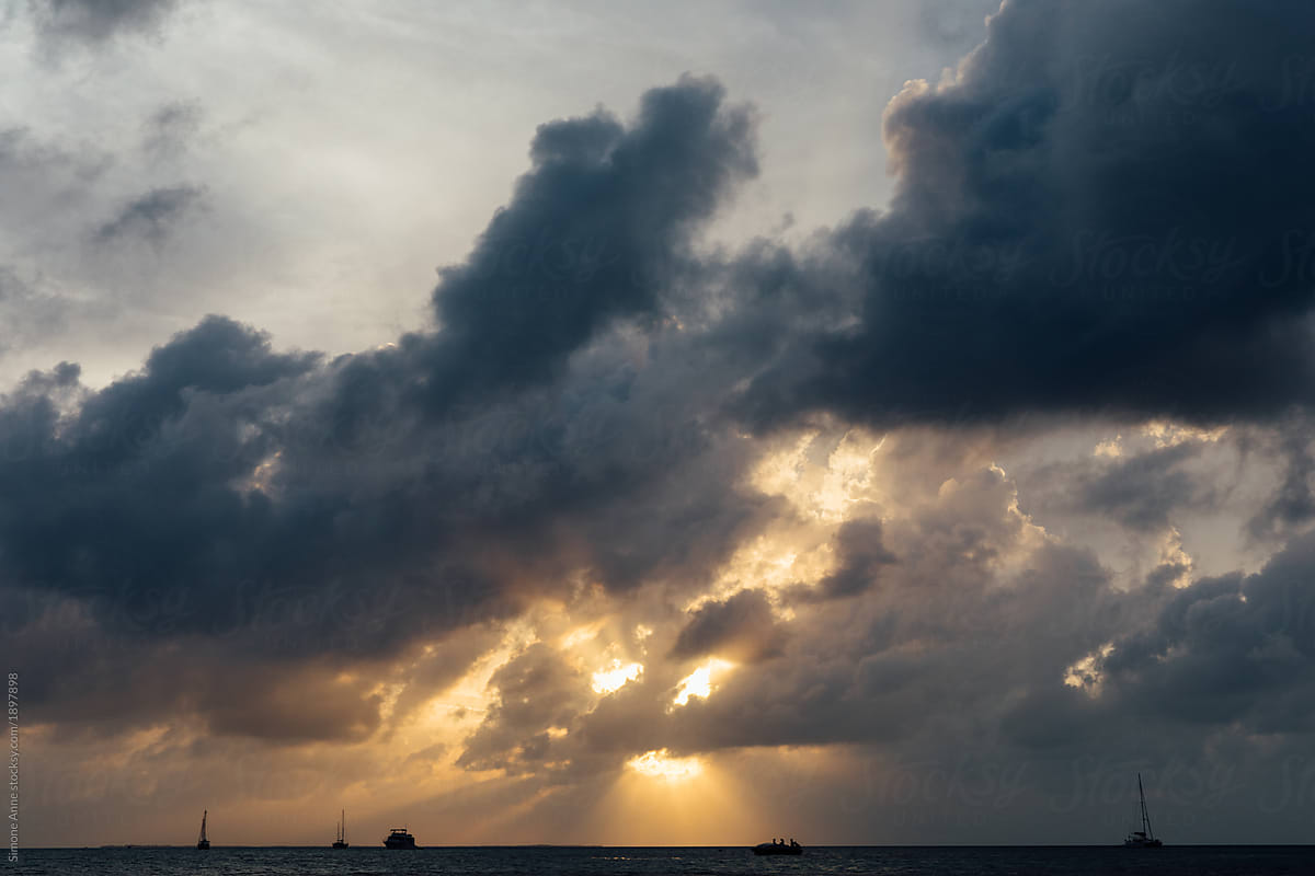 Intense sun rays coming through the clouds over the ocean in Belize
