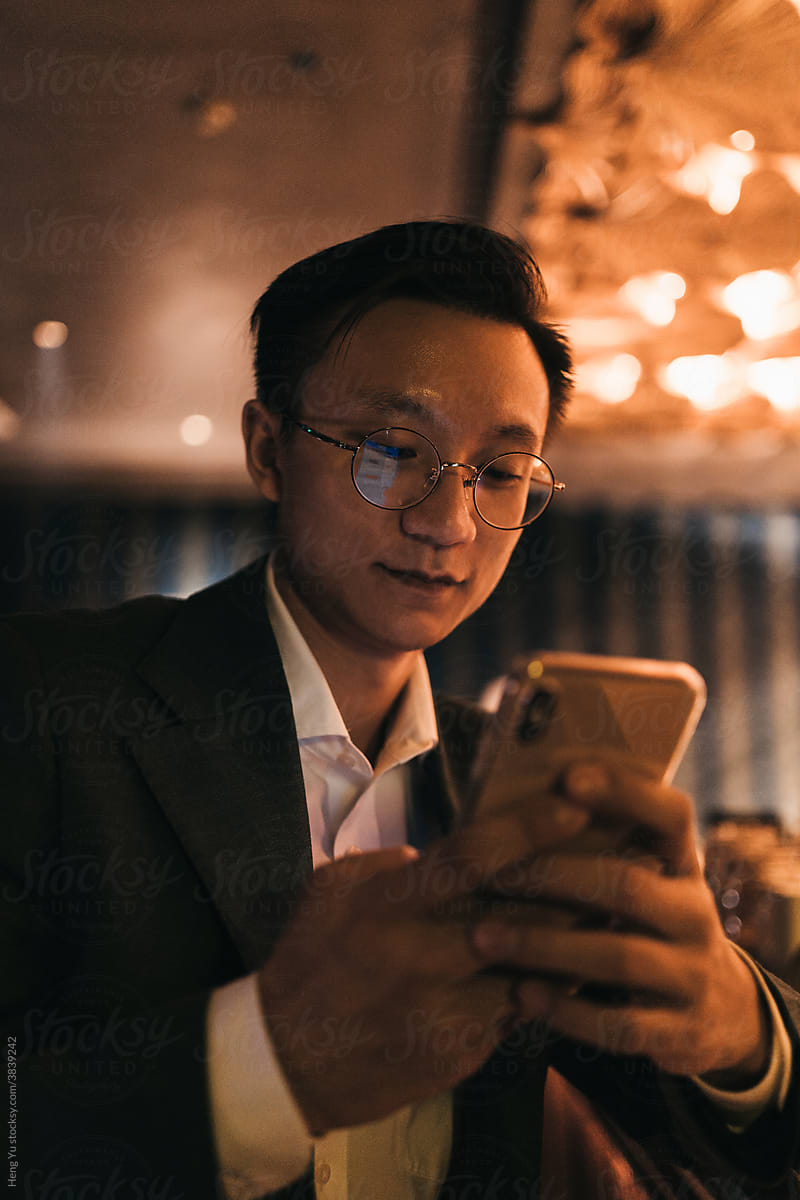 Businessman play phone in the bar