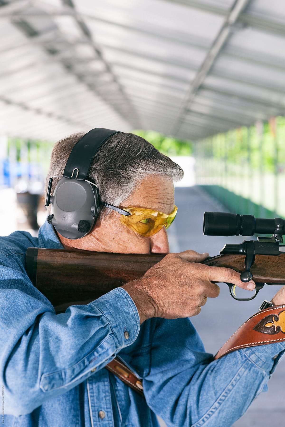 Shooting: Man Wearing Eye and Ear Protection While Shooting Rifl