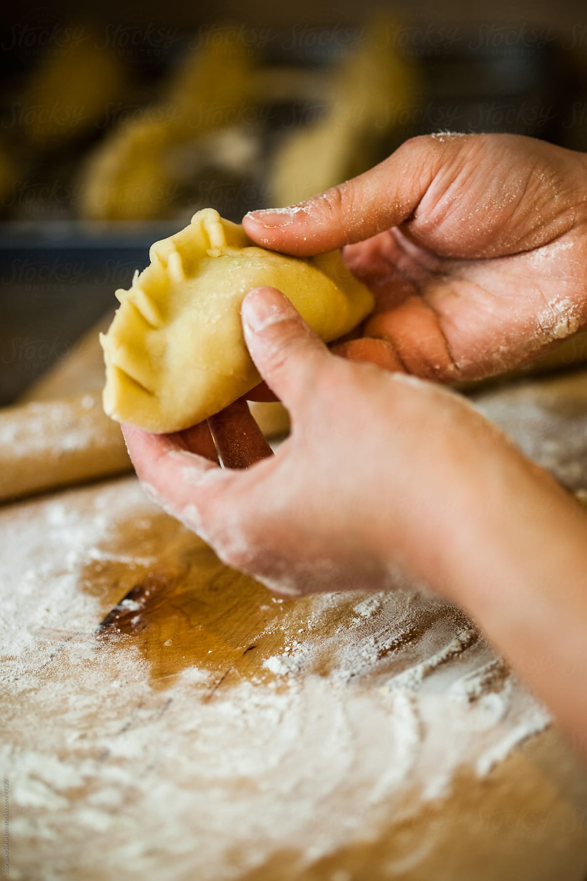 Asian food: Woman making curry puffs