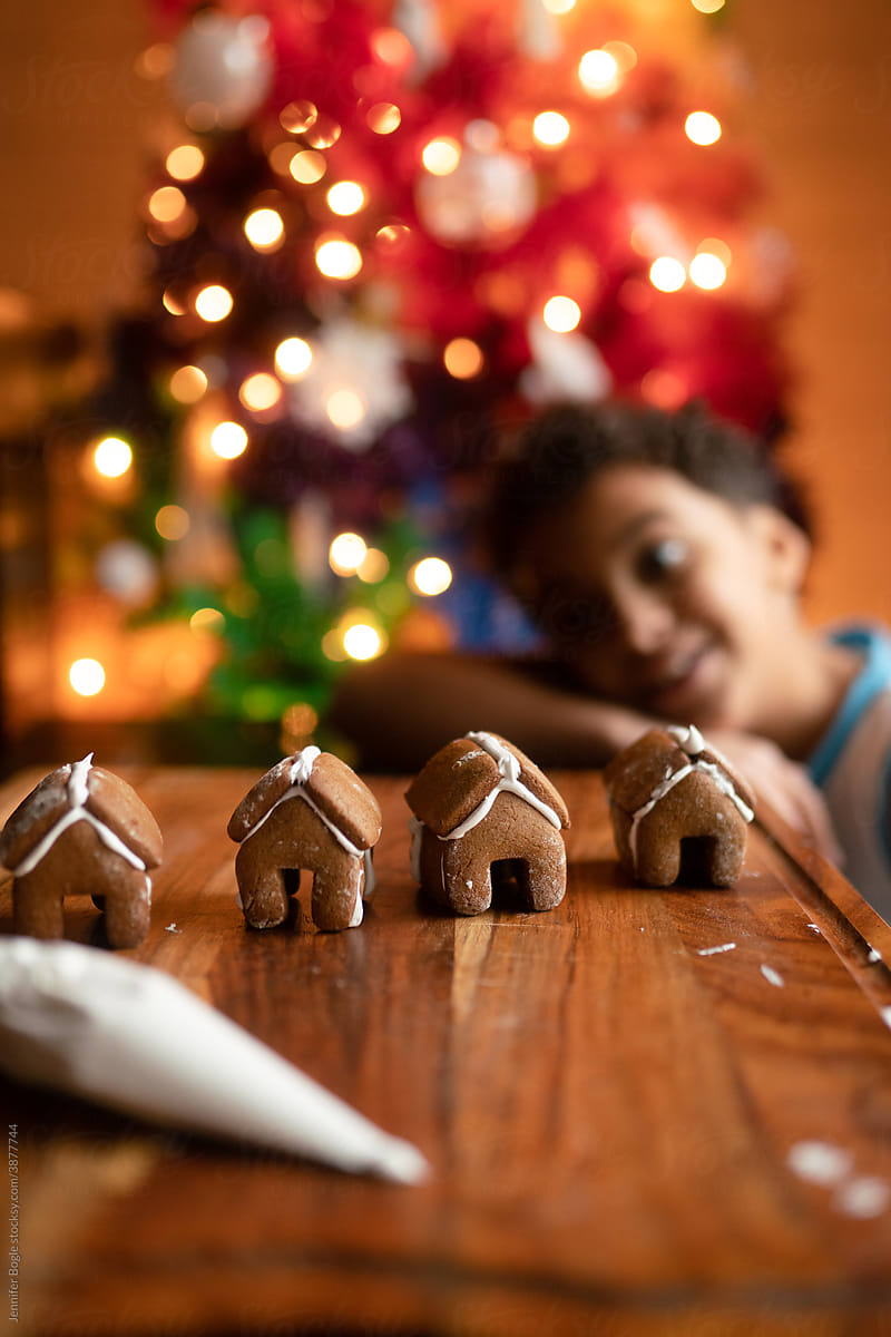 child peers at mini gingerbread houses