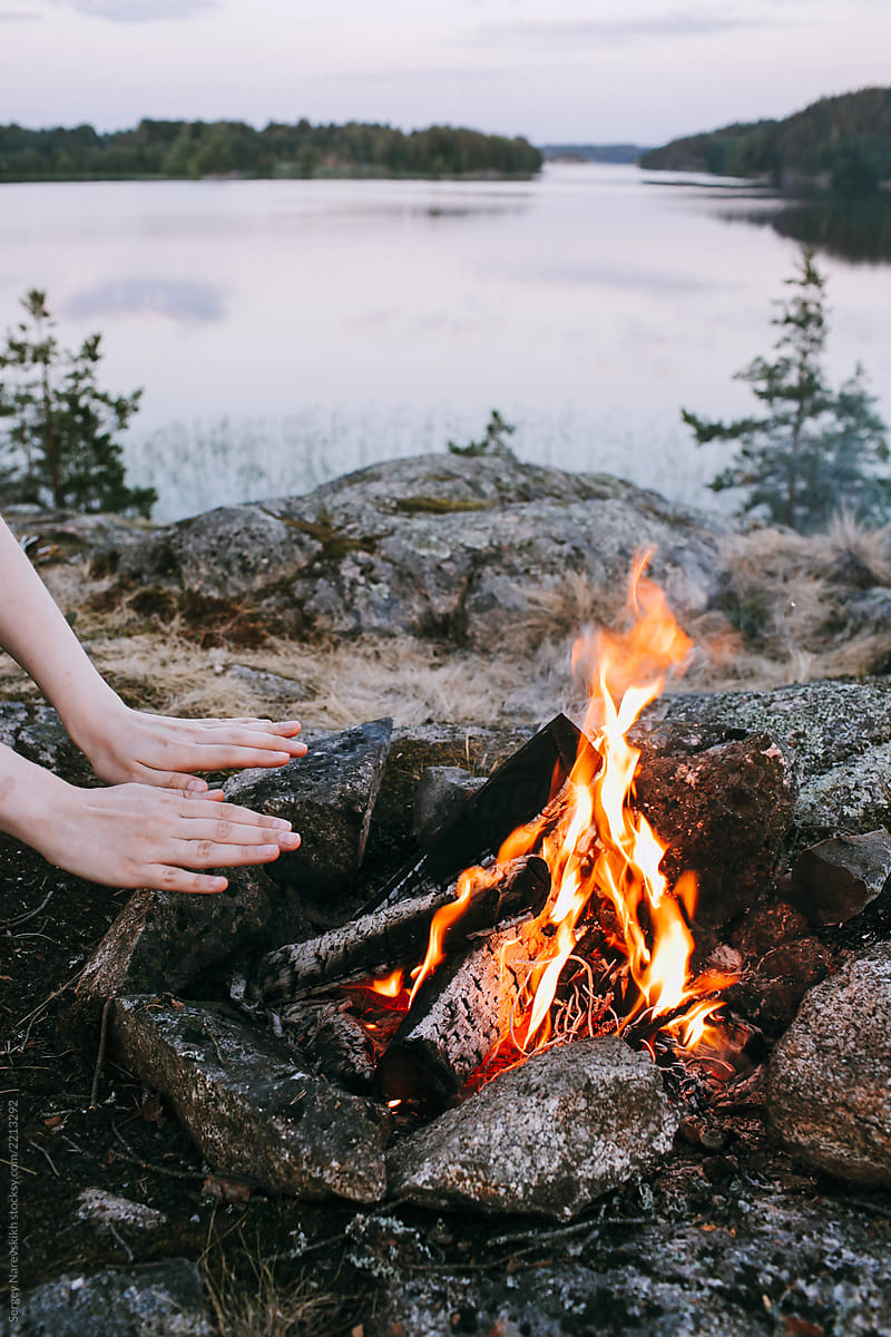 Human warm hands near fire