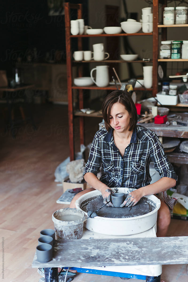 Potter Shaping Clay on Wheel in Studio