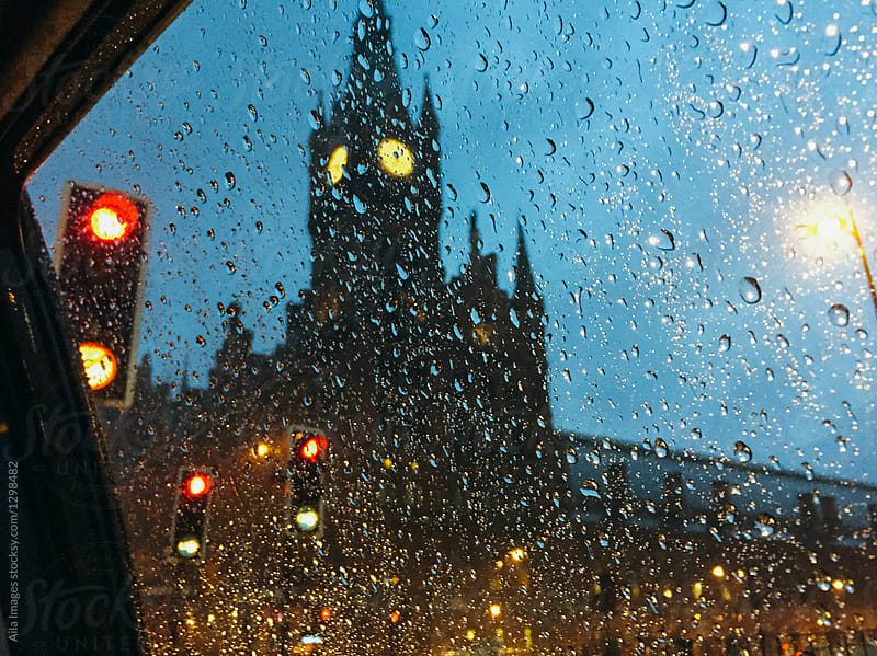 View of clock tower through rainy cab window