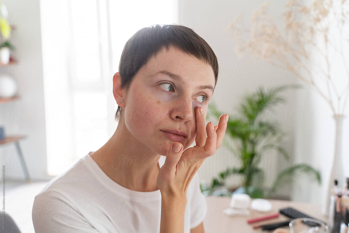 Woman Applying Make-up Using Fingers