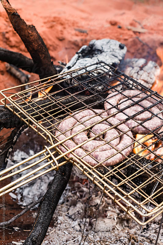 cooking boerwors sausage on an open fire in outback Australia