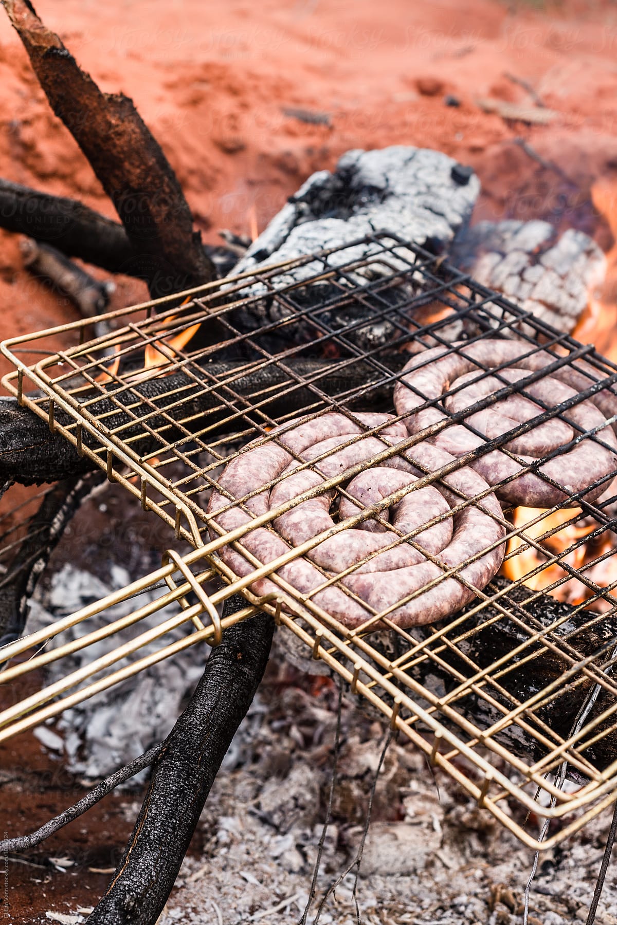 cooking boerwors sausage on an open fire in outback Australia