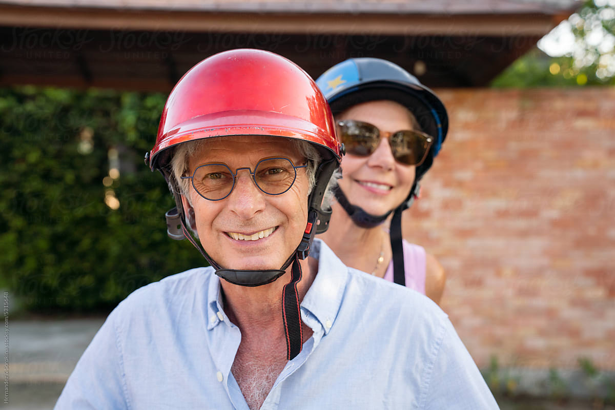 Portrait Of Senior Couple Wearing Motorbike Helmets