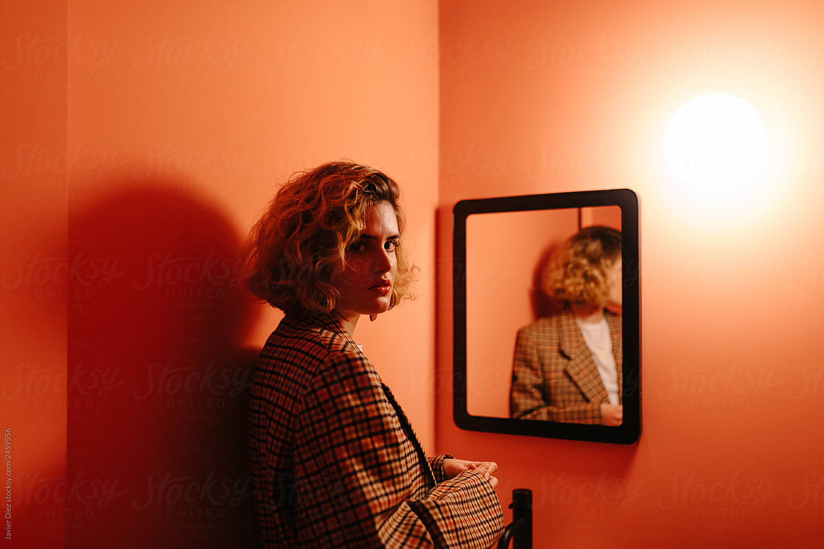Woman standing in front of mirror