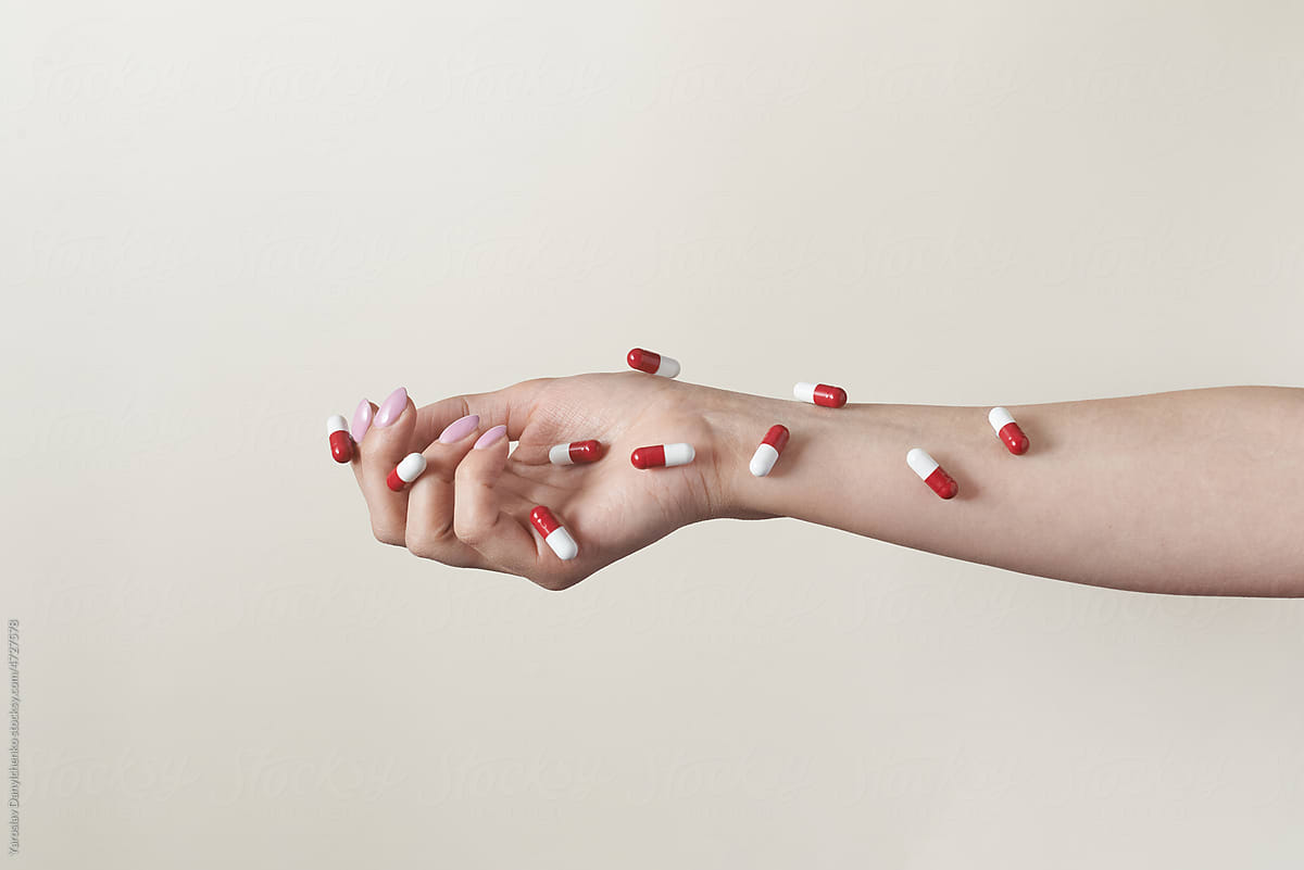 Pharmaceutical capsules over female arm.