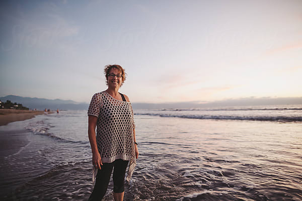 Smiling Middle Aged Man On The Beach At Sunset by Stocksy Contributor Rob  And Julia Campbell - Stocksy