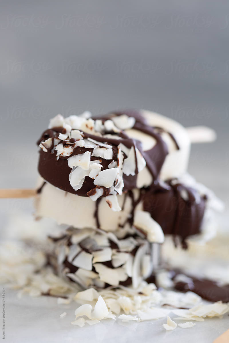 Stack of coconut ice cream coated with chocolate and coconut flakes