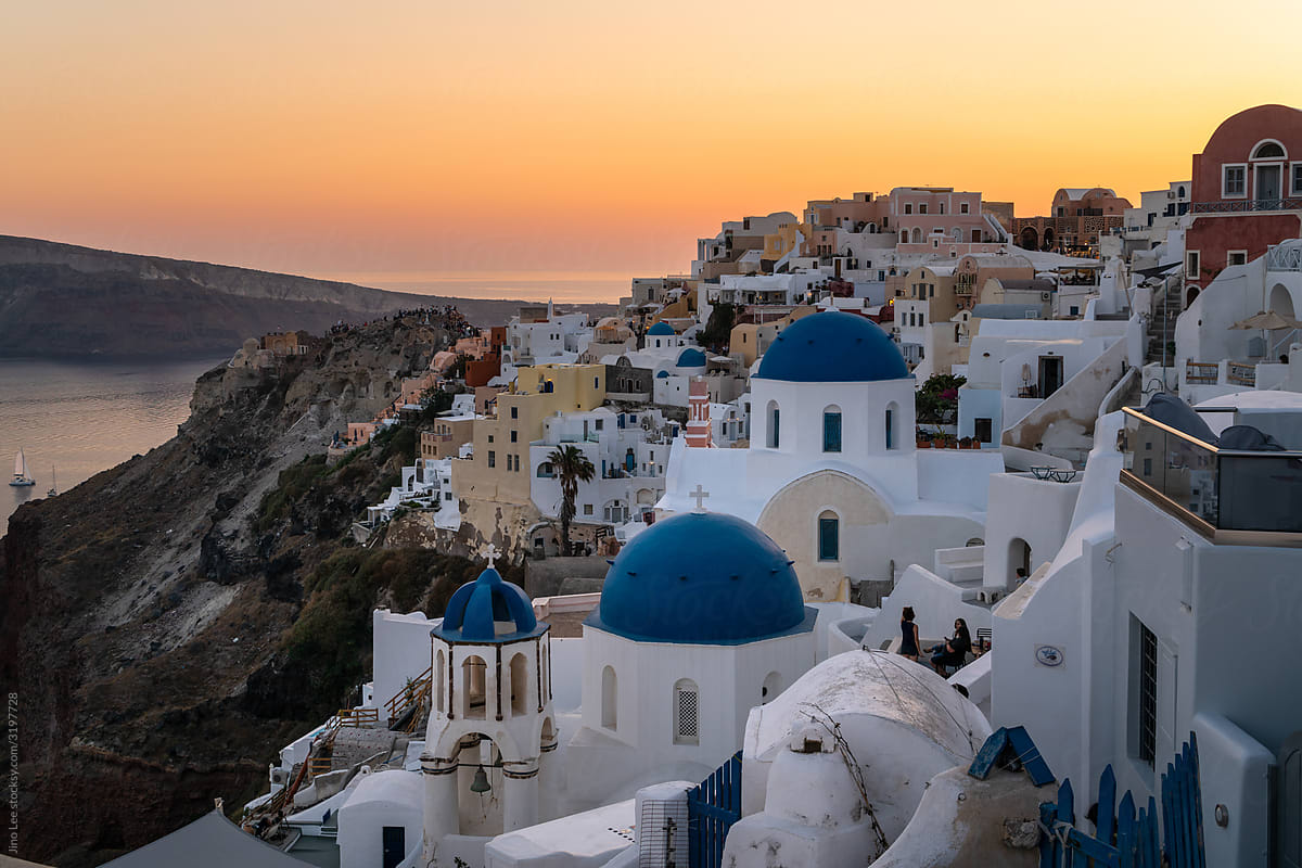 Famous blue dome church in Oia, Santorini during sunset.
