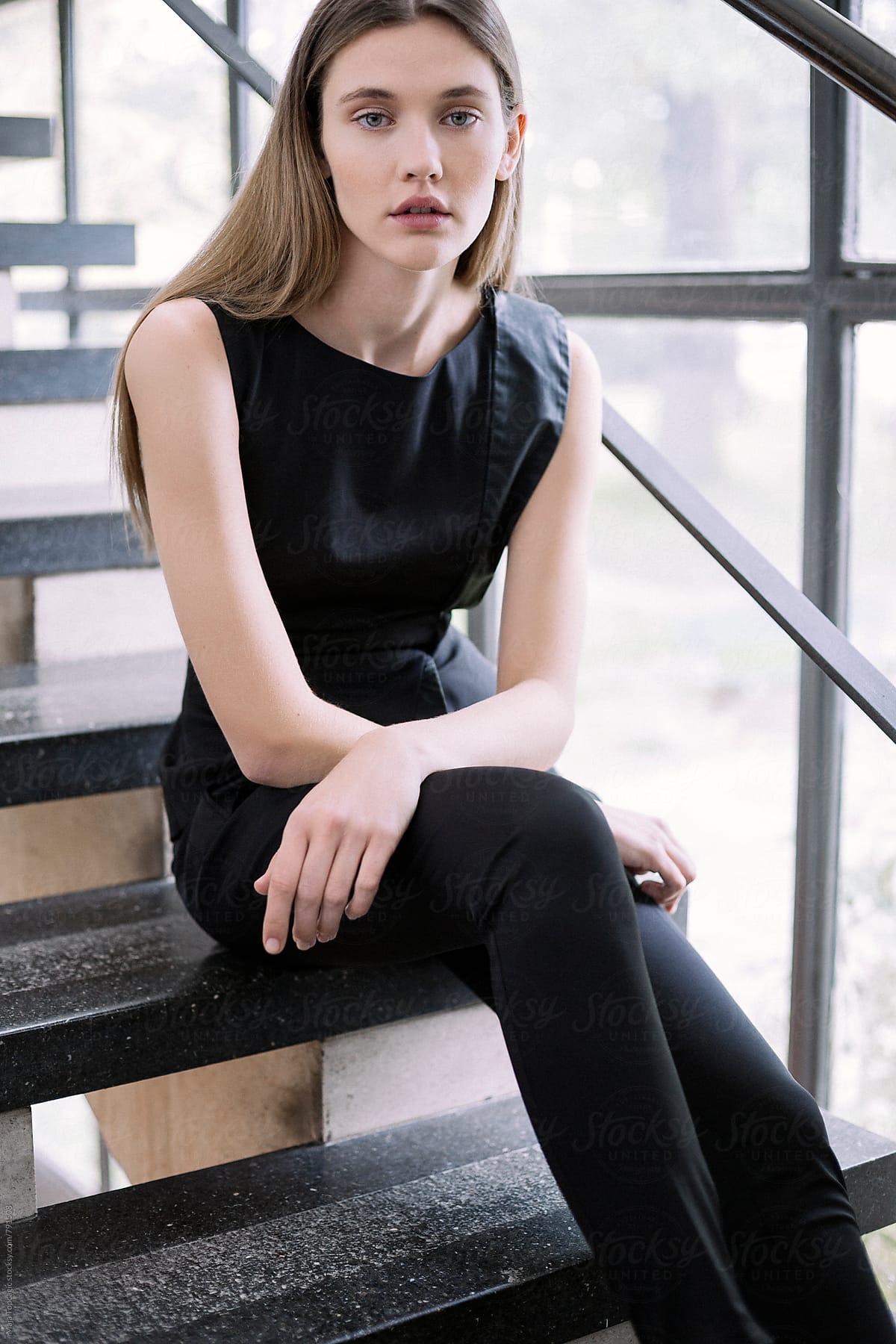 Beautiful Woman In A Black Suit Sitting On The Stairs By Stocksy Contributor Maja Topcagic