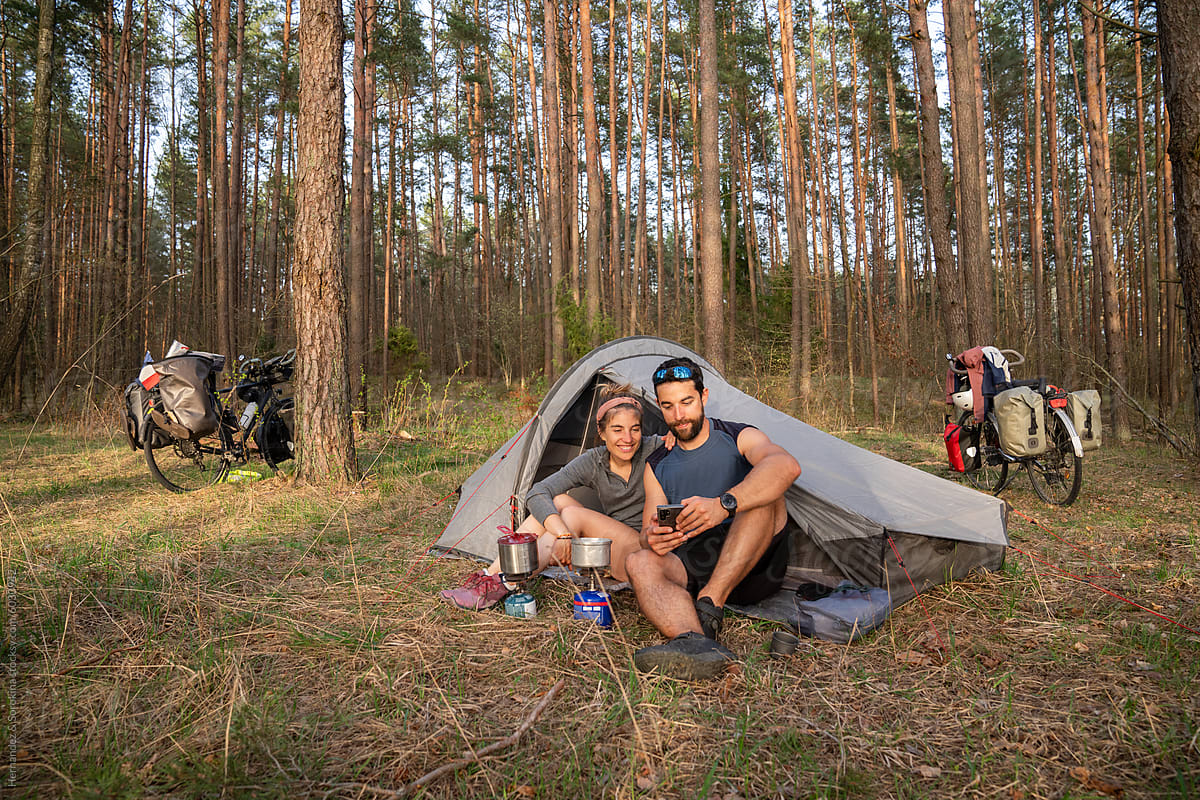 Happy Young Couple Camping In The Woods