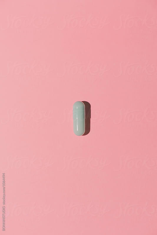 Pill on pink background from above.