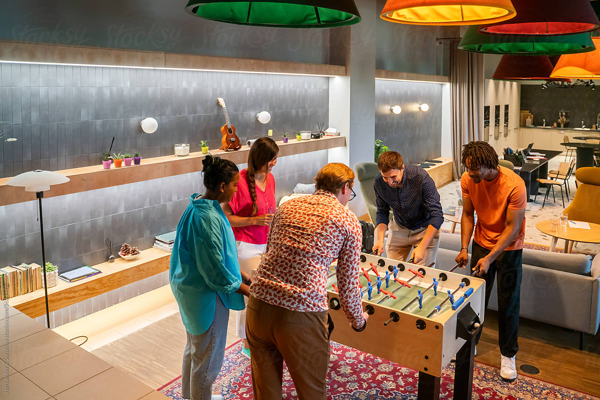 Colleagues Playing Table Football At Co-working