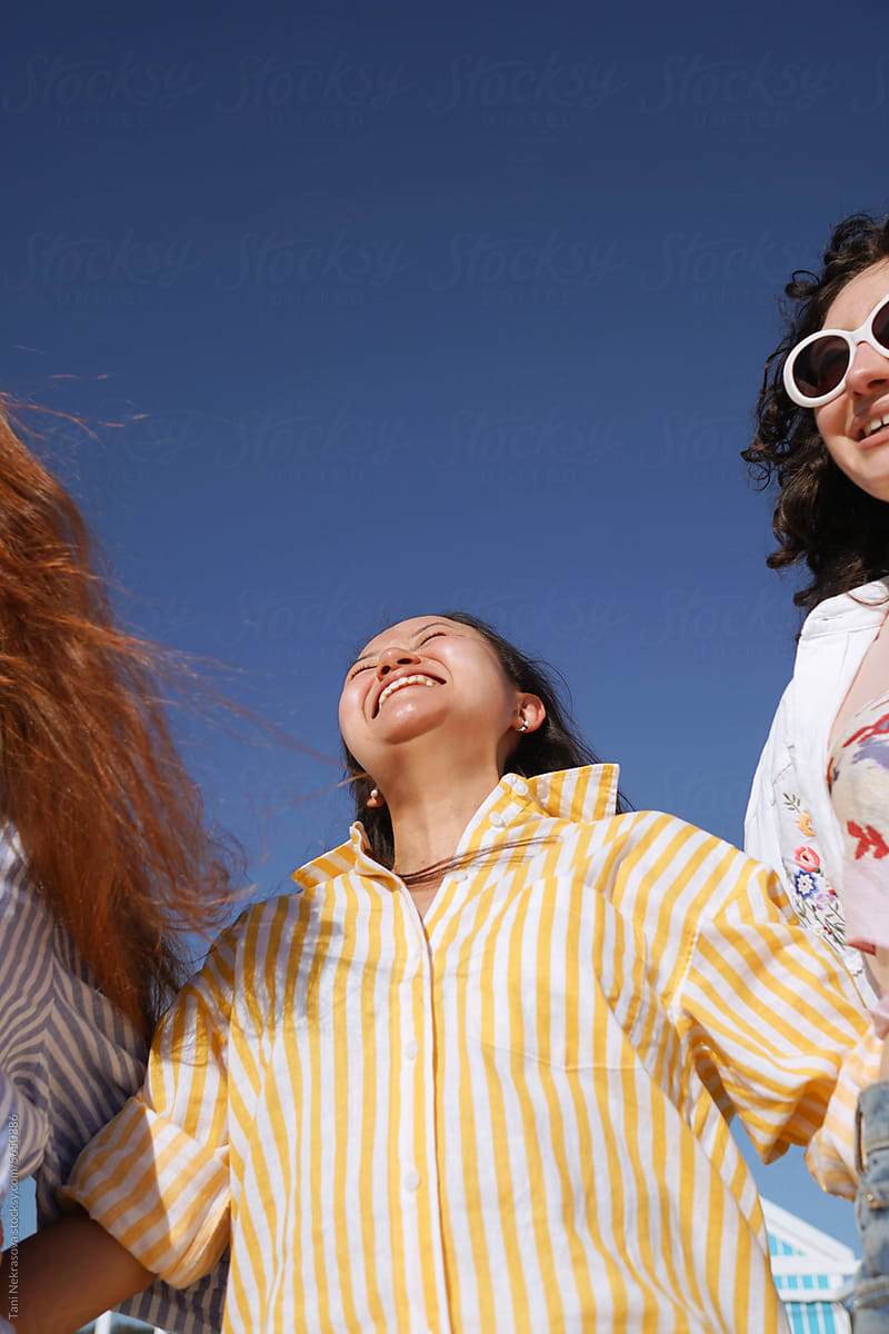 Young women smiling and laughing at the seaside