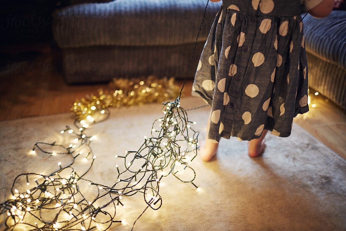 Child with fairy lights