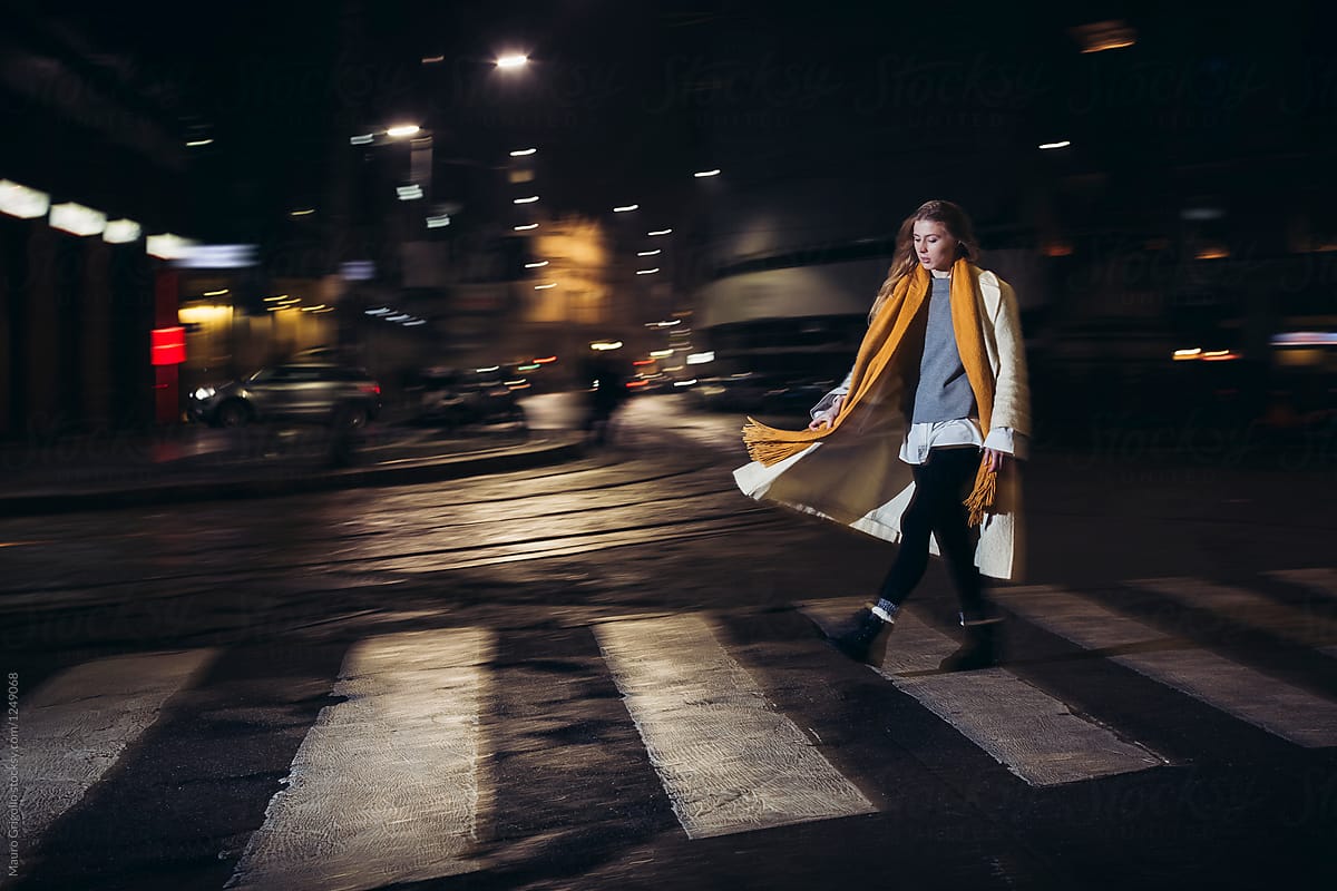 Woman walks alone in the city at night