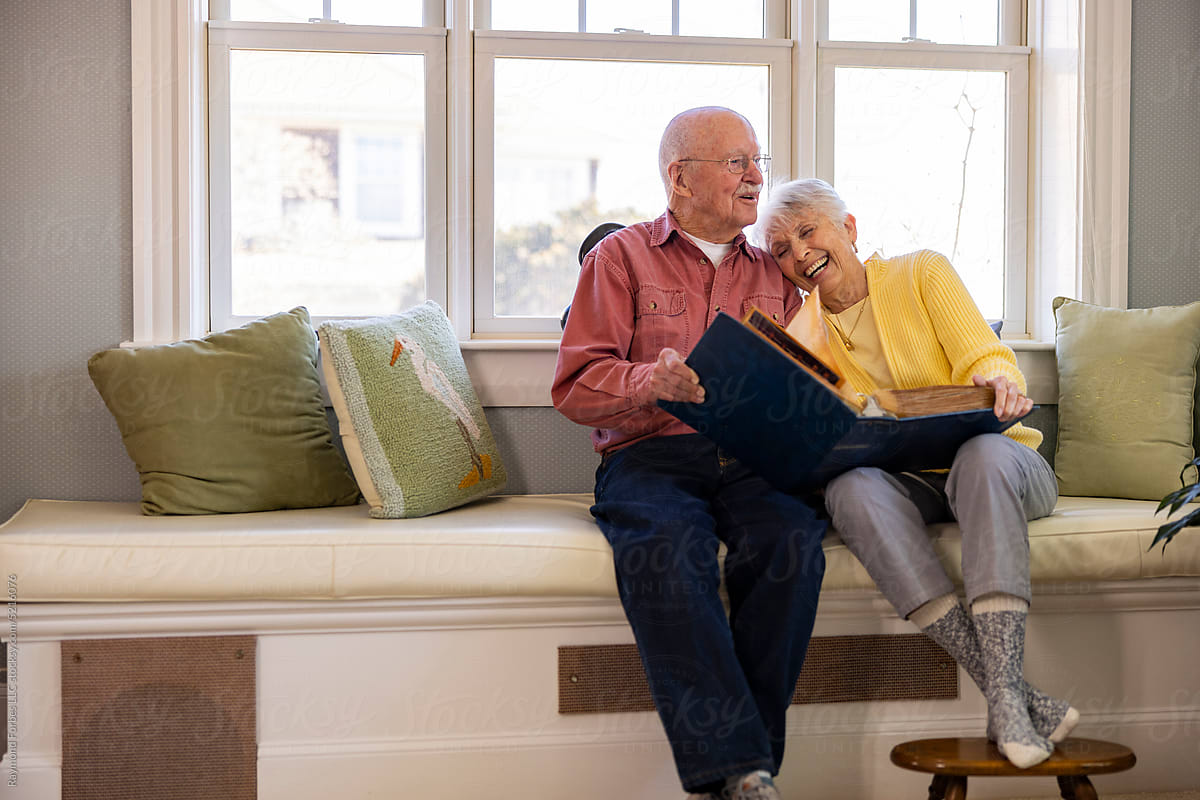 Senior Citizen couple in love  at home Looking at photo album