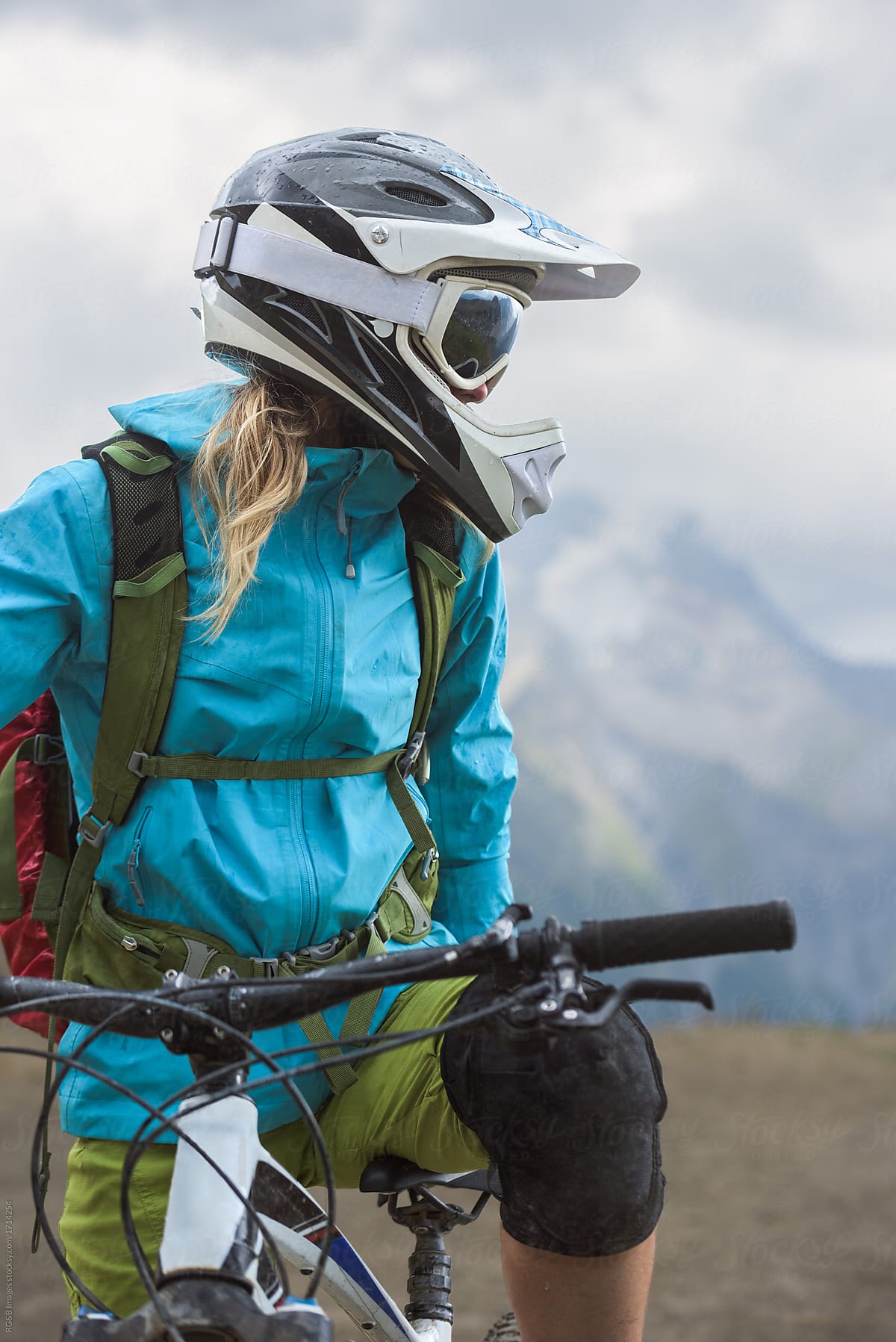 Portrait of woman with helmet and goggles with mountain bike