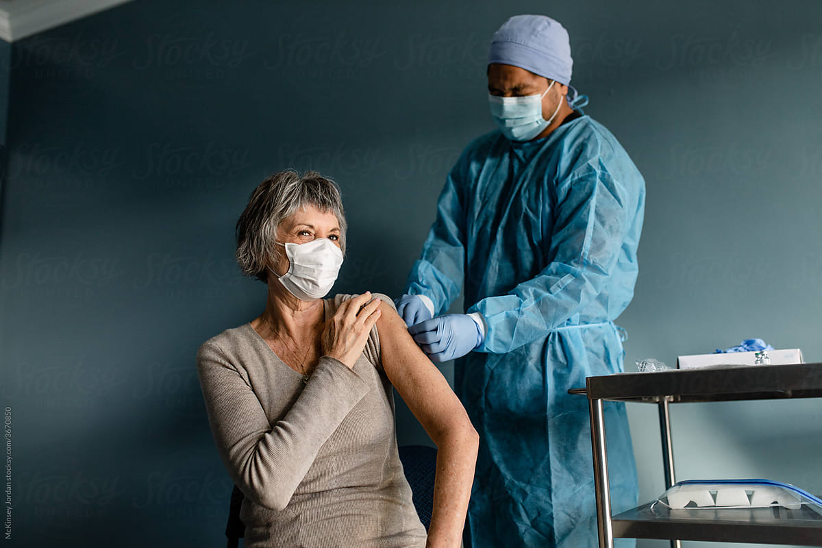 Male Nurse Puts a Bandage on Woman\'s Arm
