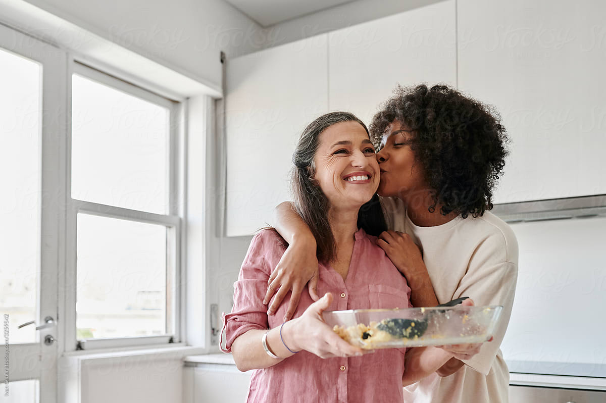 Woman Kissing Her Friend After A Dinner Party By Stocksy Contributor Ivan Gener Stocksy