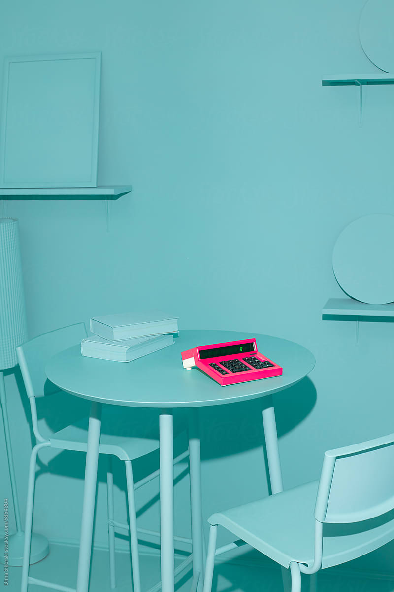 Pink calculator in a room with monochrome design