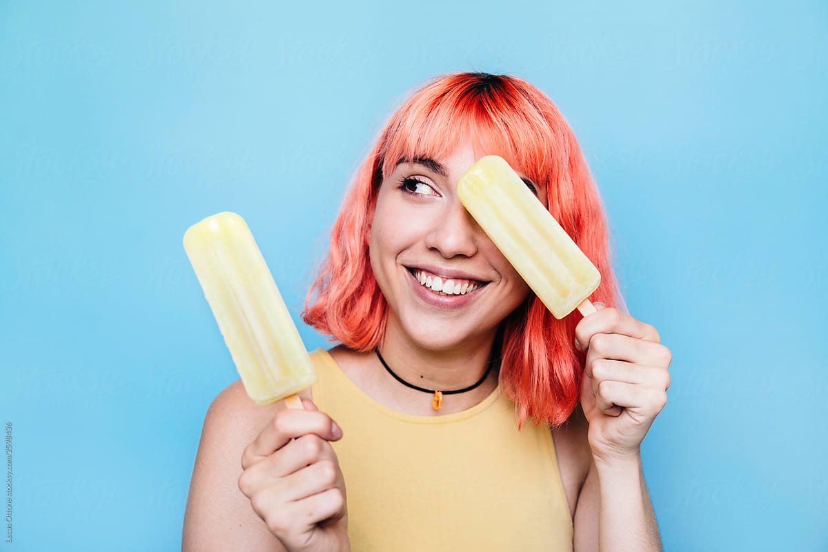 Young woman with lemon ice lollies