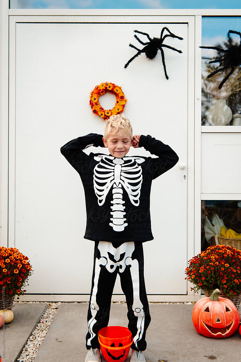 Boy in skeleton outfit, ready for trick or treating on Halloween