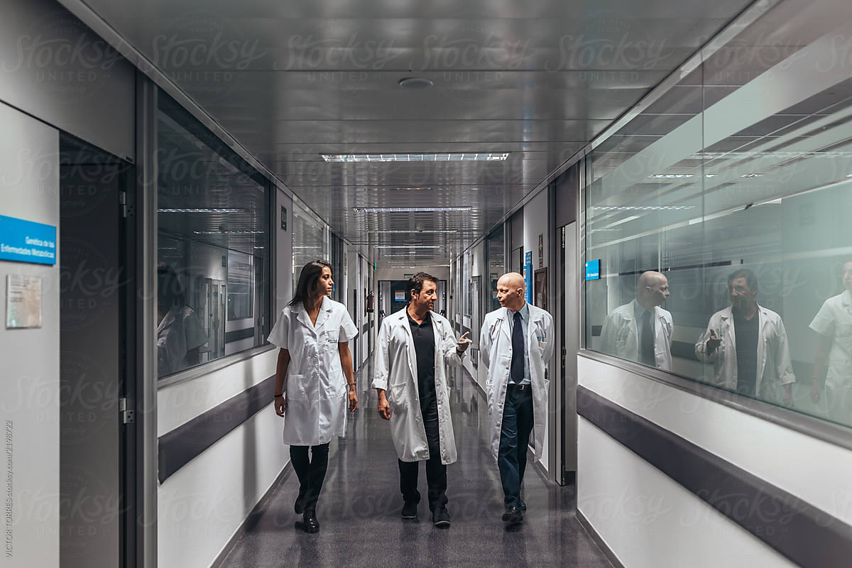 Doctors walking through A hospital corridor in a professional la