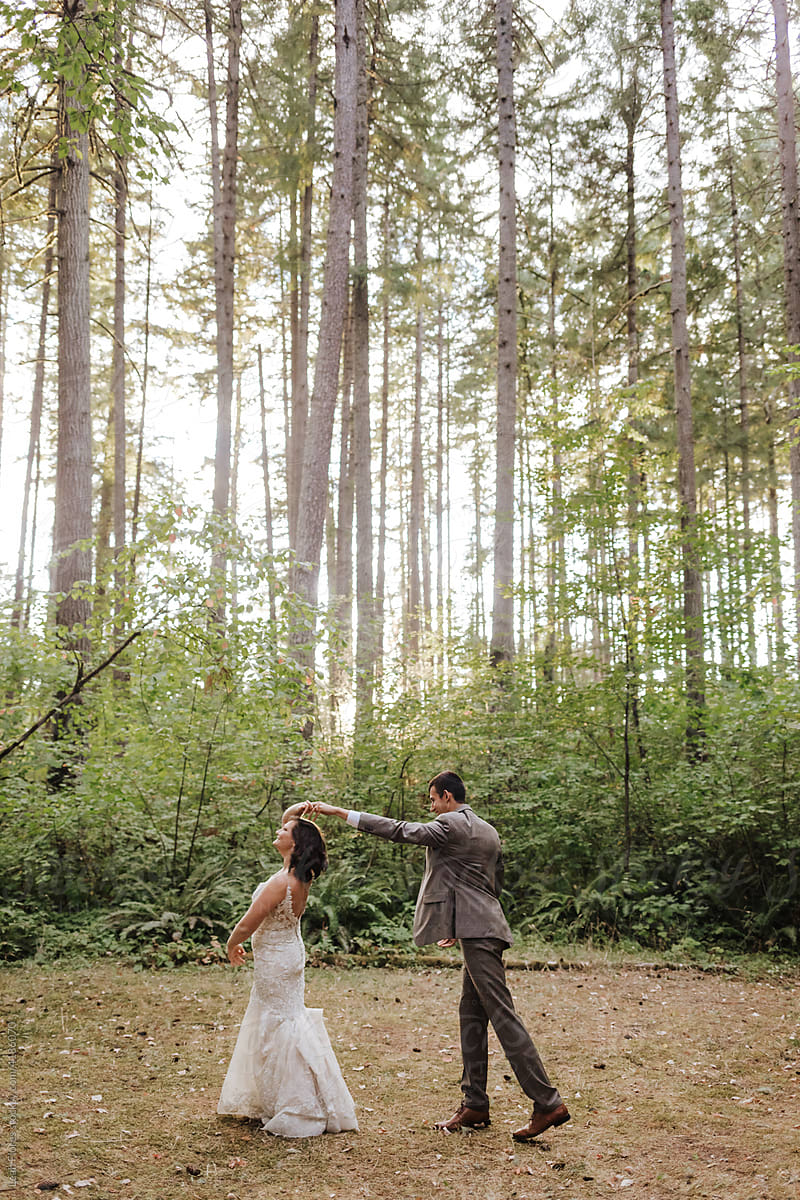 Bride and Groom Dancing in Forest