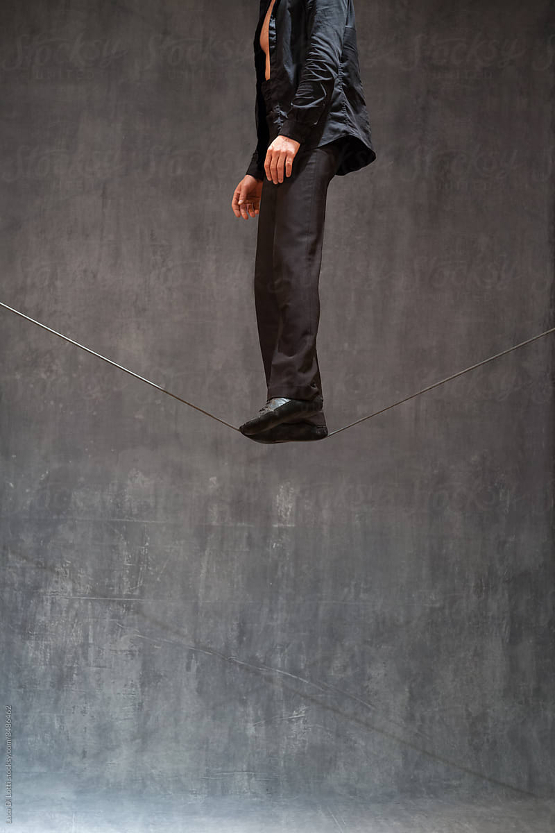anonymous man standing on a rope