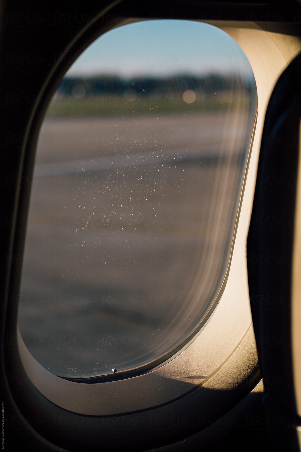 Airplane Window With Some Frost Left From the Flight