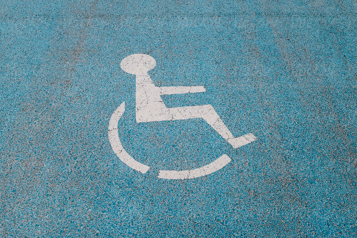 White disabled symbol painted onto blue surface