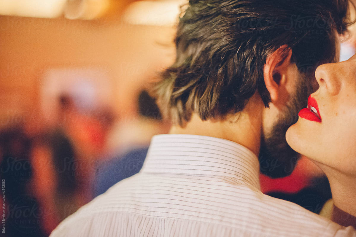 A Woman\'s Red Lips Whispering into a Man\'s Ear