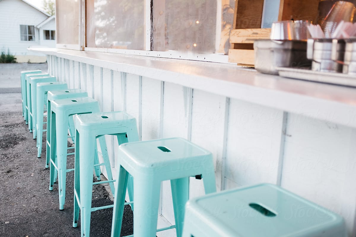 bright blue classically designed vintage colored stools outside old diner