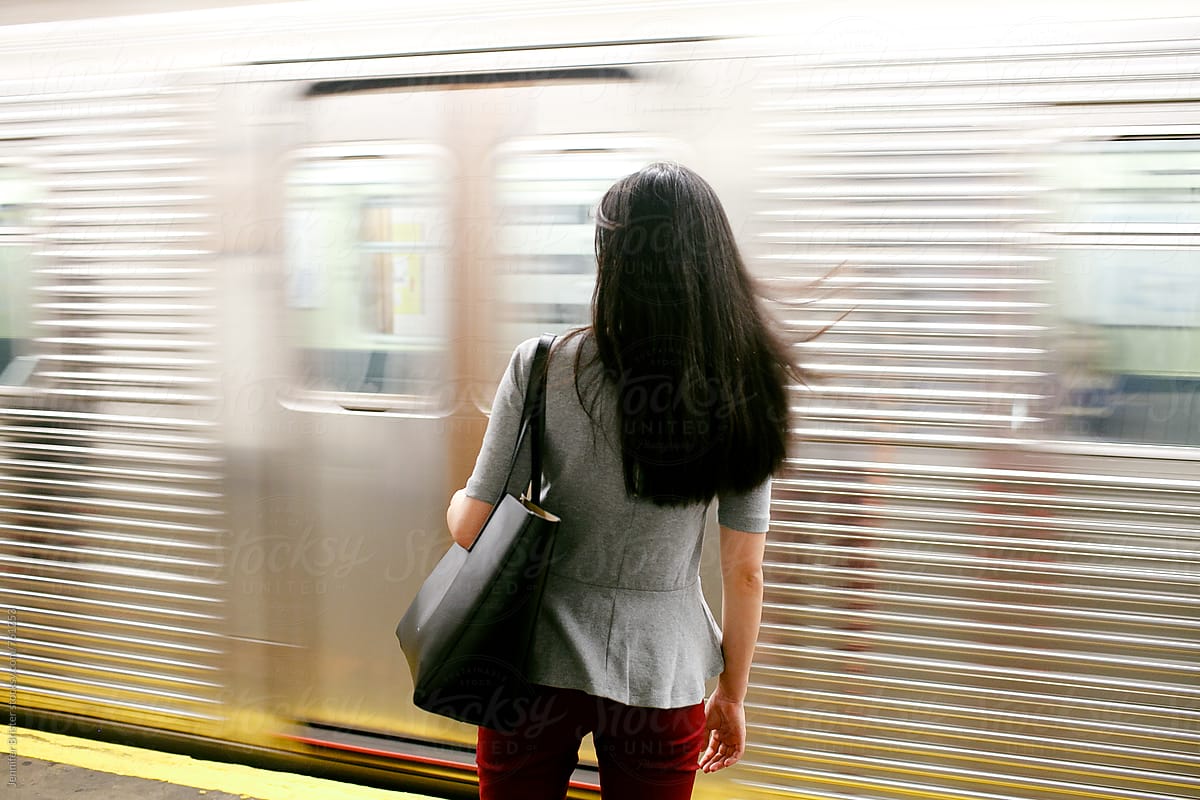 Woman standing near passing subway